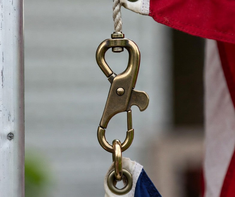 USA flagpole snap hook attached to flag grommet on halyard rope
